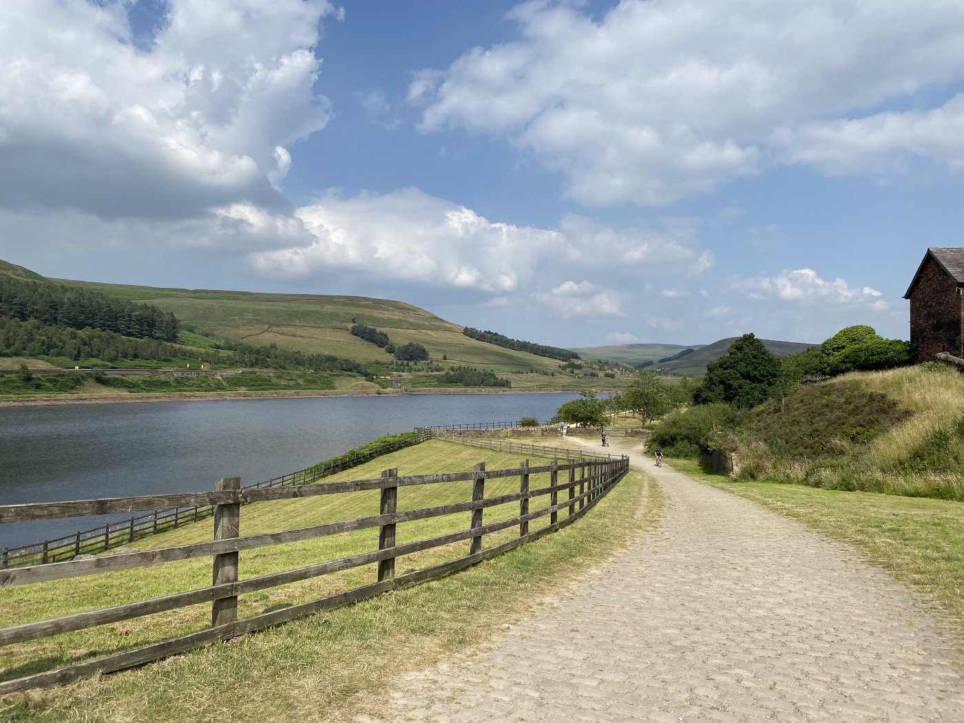 Wide cobbled bridleway above a reservoir on the Trans-Pennine Trail